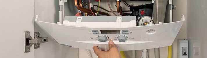 Opening front panel of boiler.